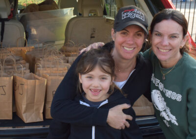 The mother/daughter team who spearheaded the initiative pose with Mrs. Vaisman.