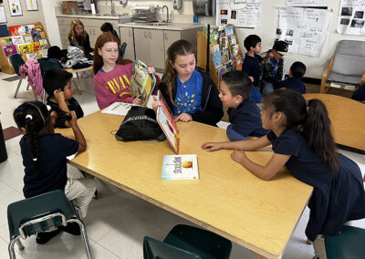 5th graders read to their kindergarten buddies before donating the books to the Para Los Ninos school library.