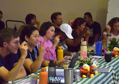 Teachers display the alphabet in ASL.
