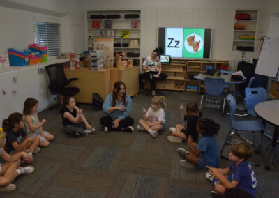 Kindergarteners begin with the alphabet in ASL.