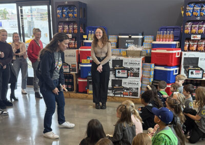 Mrs. Vaisman welcomes the kindergarteners to Pavilions before shopping.
