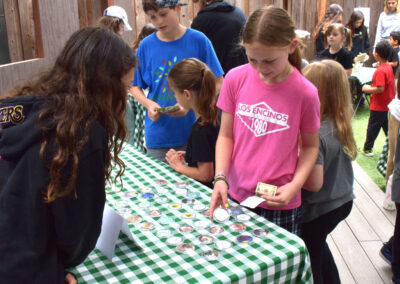 4th graders sell handmade buttons with environmental messages at the "shade sale."