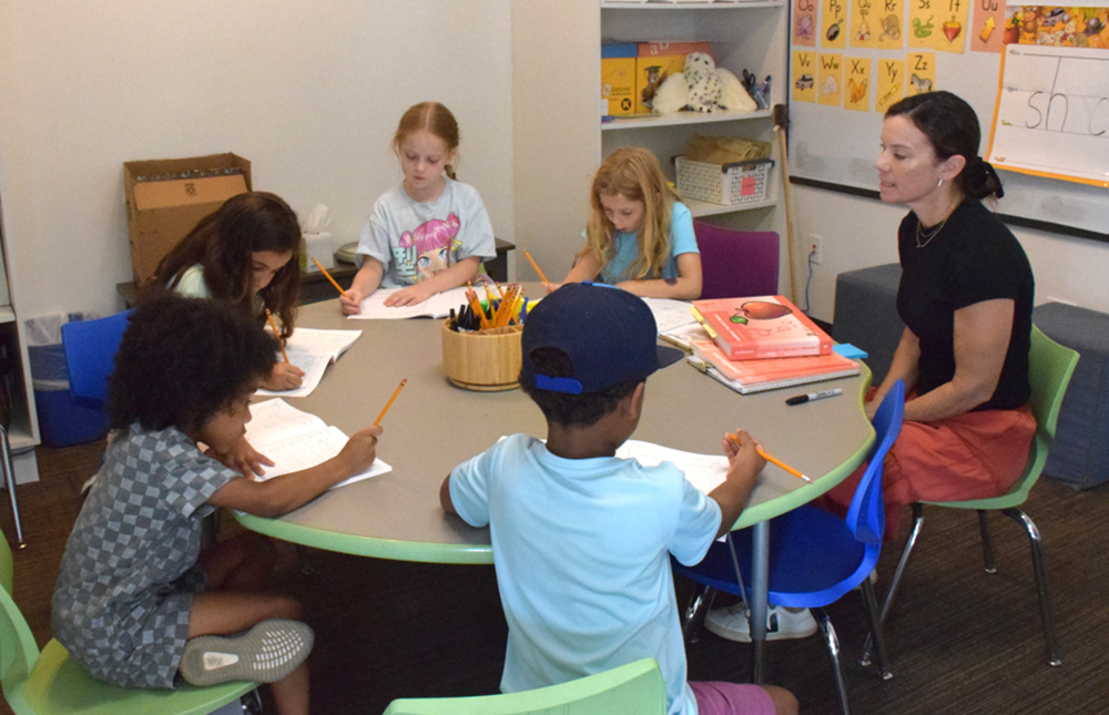 A small reading group meets in a breakout room. A small reading group meets in a breakout room.